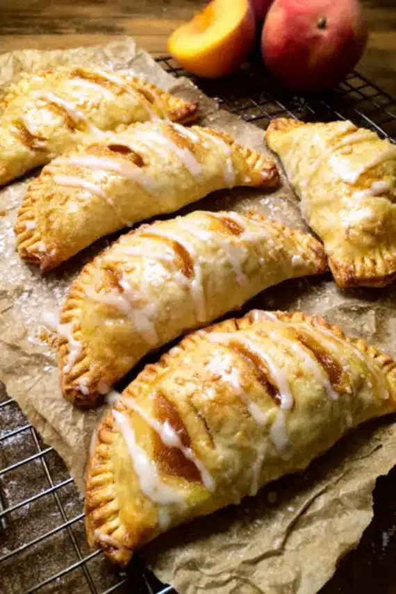 Fresh baked peach hand pies with golden crust and visible peach filling