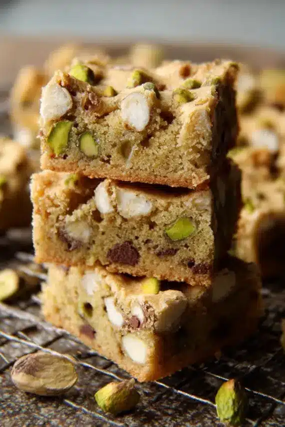 Freshly baked pistachio blondies with visible nuts and melted chocolate chunks