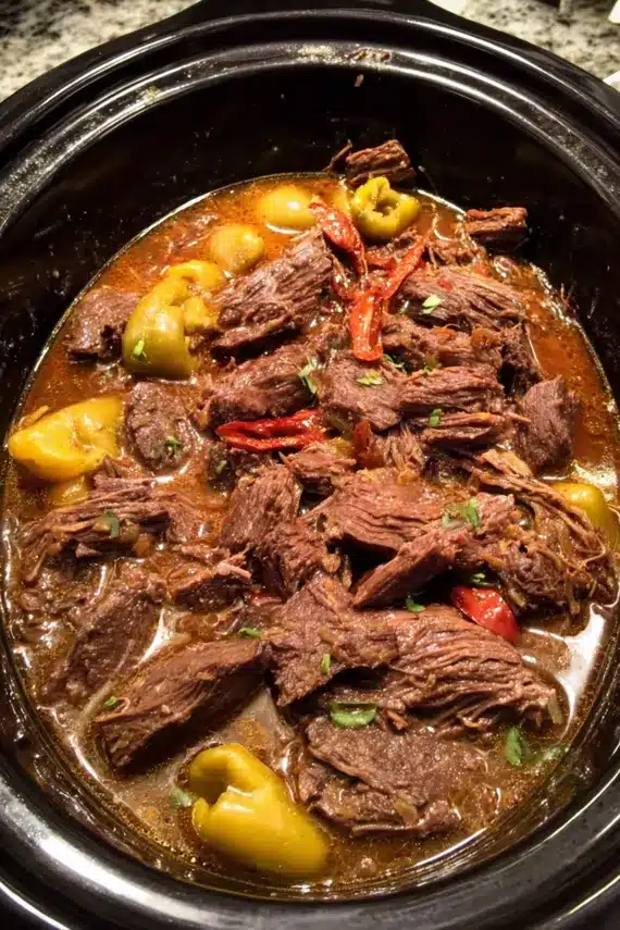 Slow Cooker Pepperoncini Beef served over mashed potatoes with vegetables