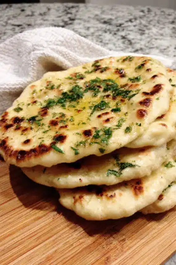 Perfectly cooked homemade naan bread with golden-brown spots and a soft texture