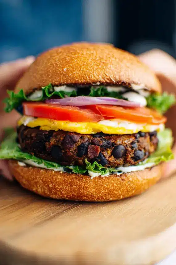 Spicy black bean patty served in a deconstructed burger bowl