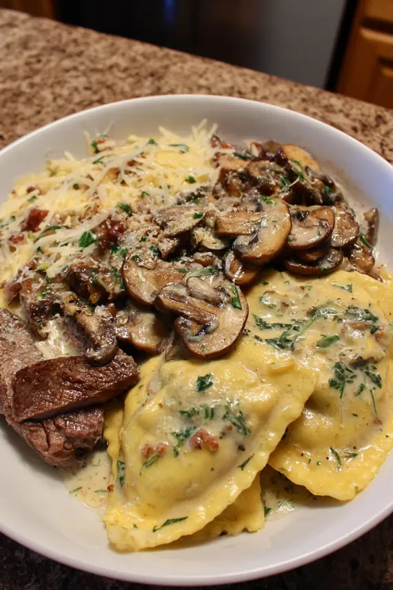 Plated steak mushroom ravioli with sage butter sauce and garnish