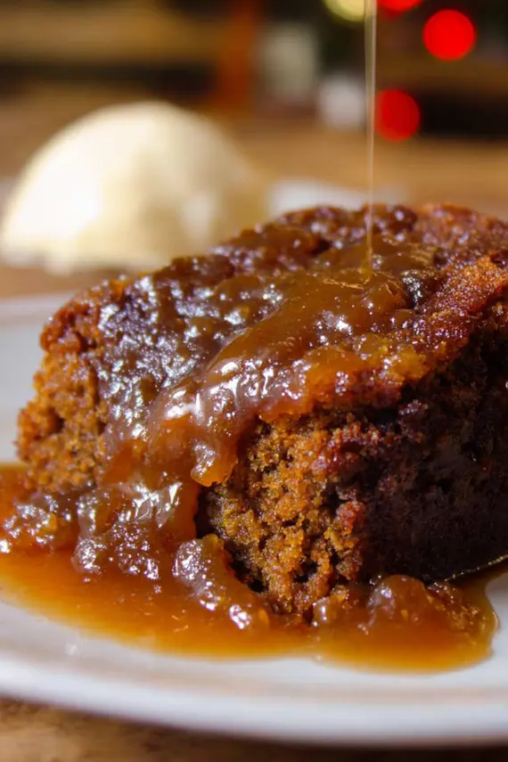 Gingerbread Sticky Toffee Pudding with toffee sauce being poured over top