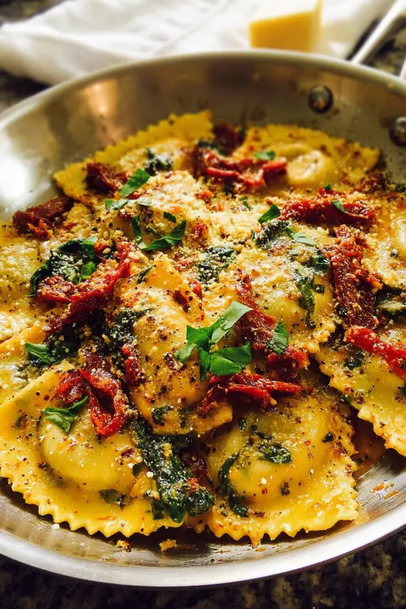Sun dried tomato sauce being drizzled over fresh homemade ravioli