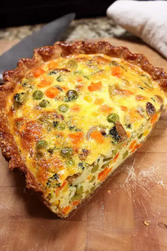 Freshly baked mixed vegetable quiche with golden crust and colorful vegetables