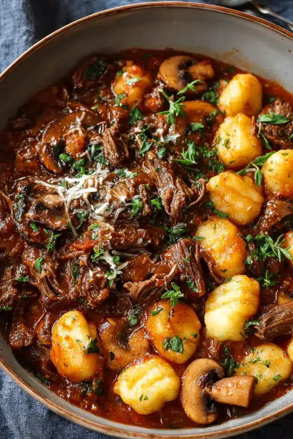Homemade beef ragu sauce with mushrooms in a pot