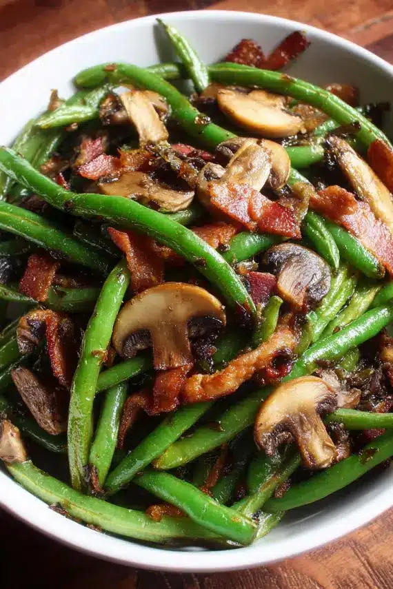 Fresh green beans bacon mushrooms side dish in a skillet