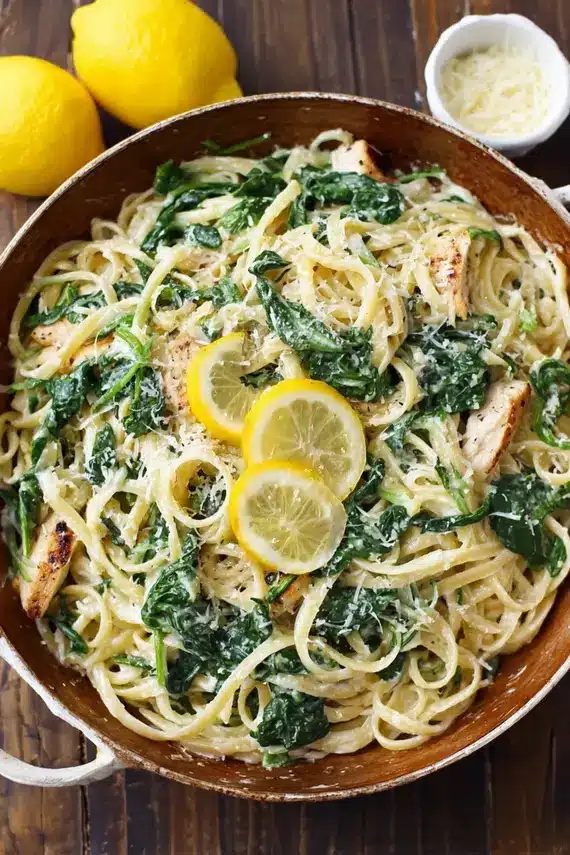 Freshly made lemon ricotta spinach pasta in a white bowl