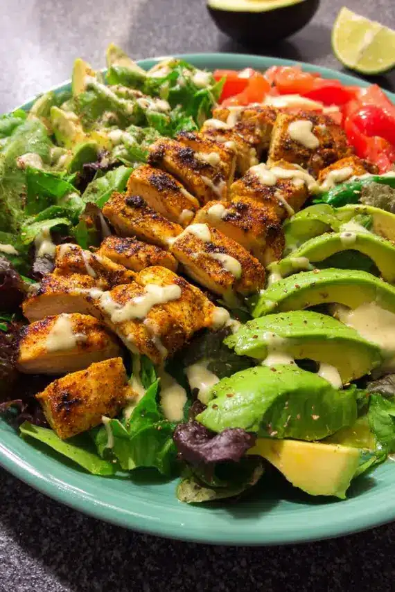 Fresh lime vinaigrette being drizzled over chipotle chicken salad
