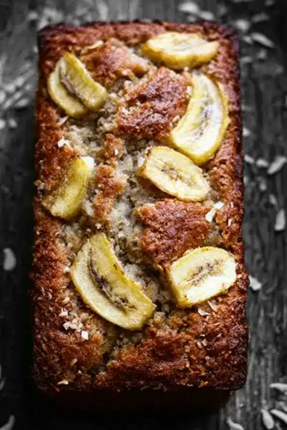 Sliced banana pineapple coconut bread served with fresh fruit