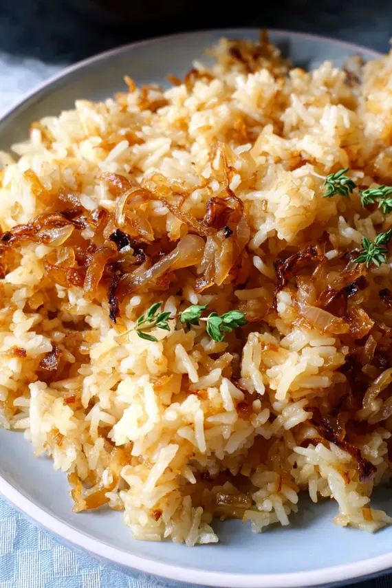 Delicious French onion butter rice in a serving bowl showing caramelized onions mixed with fluffy rice