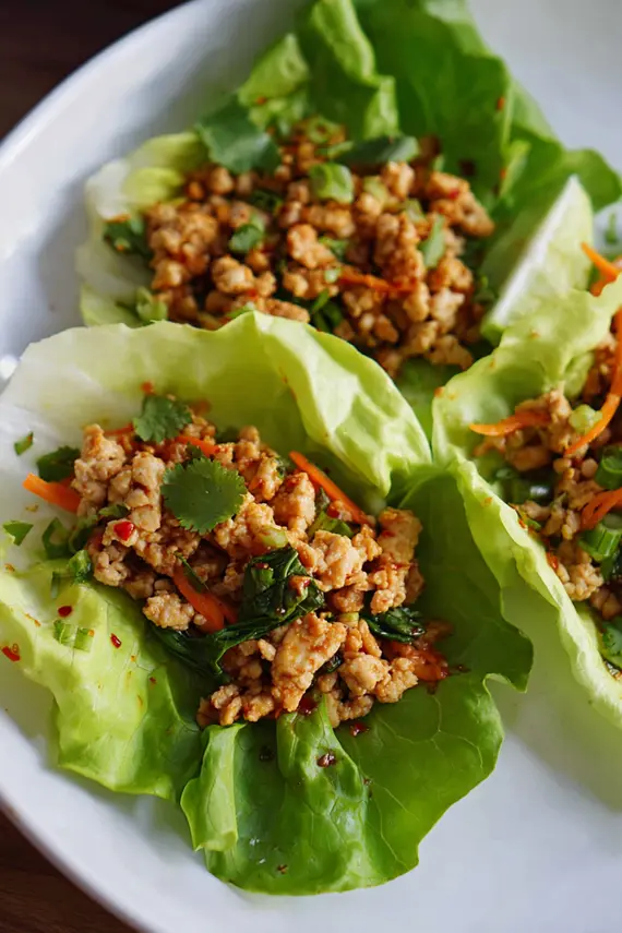 Delicious chicken lettuce wraps with Thai chili sauce in a pan ready to be served