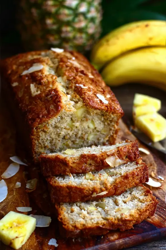Freshly baked banana pineapple coconut bread cooling on a wire rack
