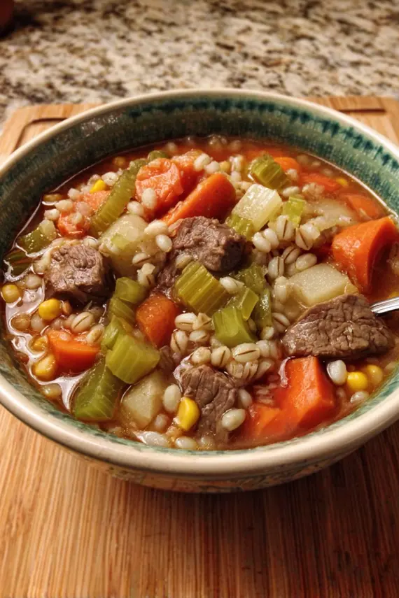 Hearty beef barley soup with vegetables in a bowl