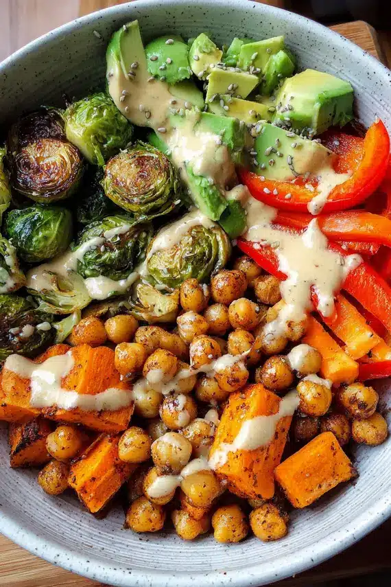 Freshly prepared chickpea veggie bowls with tahini dressing showing colorful vegetables and protein-rich chickpeas