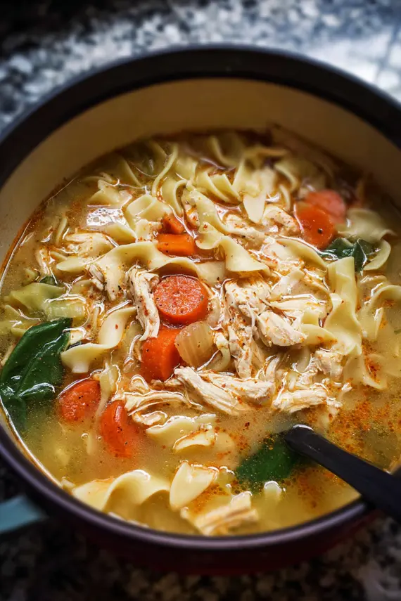 Marry me chicken soup served with crusty bread in a cozy setting