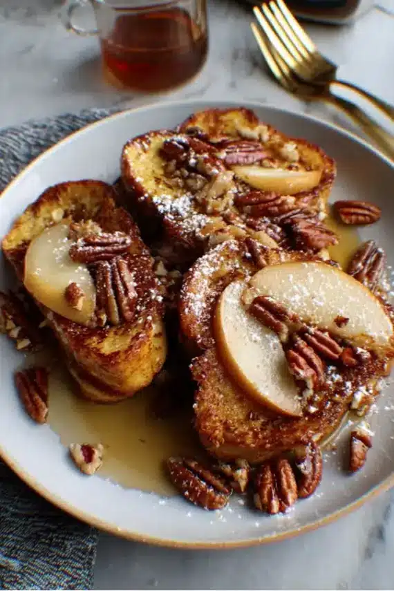 Golden challah french toast topped with apple pear pecan mixture