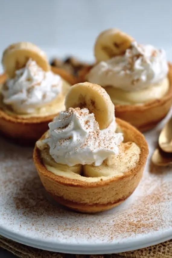 Beautifully arranged mini banana pudding pies served on a dessert platter