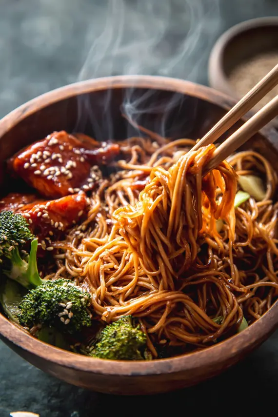 Perfectly cooked honey sesame salmon noodles in a skillet