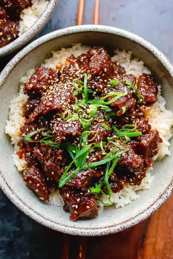 Korean slow cooker beef bites in a bowl with sauce