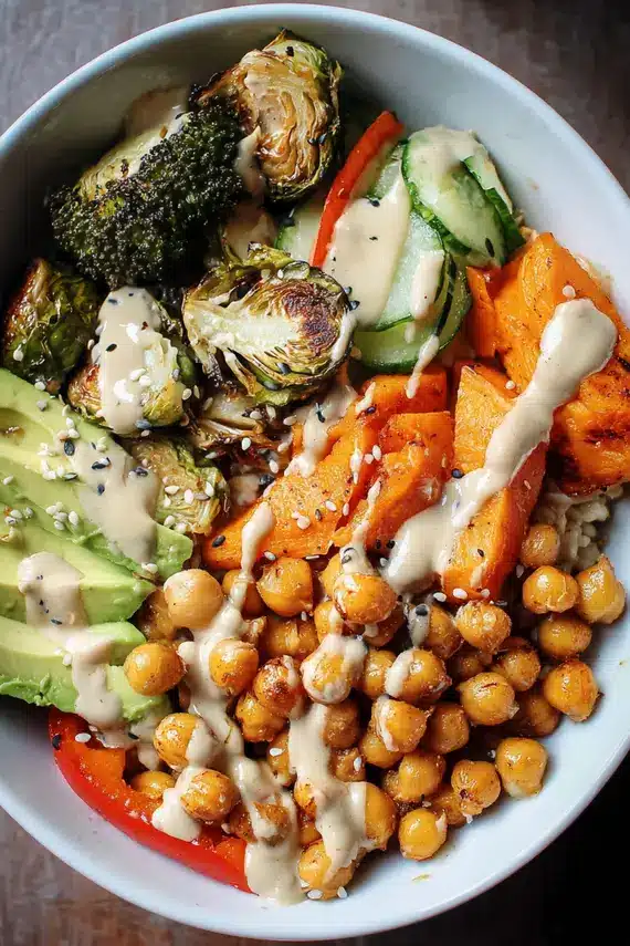 Beautifully served chickpea veggie bowls with tahini dressing in attractive serving bowls ready to enjoy